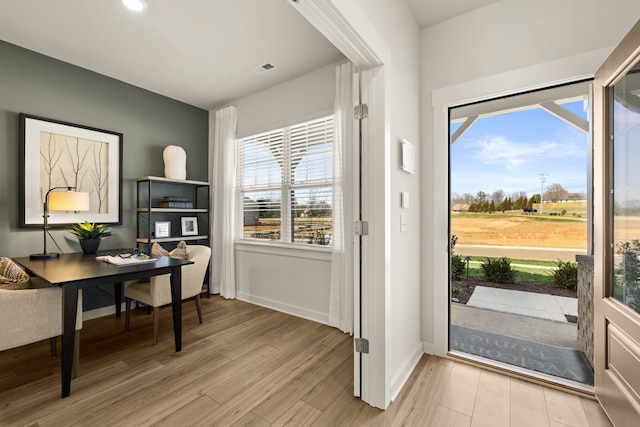 doorway to outside with light hardwood / wood-style floors and a healthy amount of sunlight