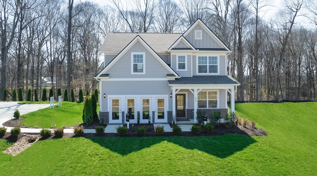 craftsman house featuring a front lawn and a porch