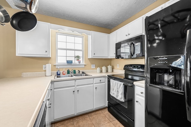 kitchen featuring white cabinets, black appliances, a textured ceiling, and sink