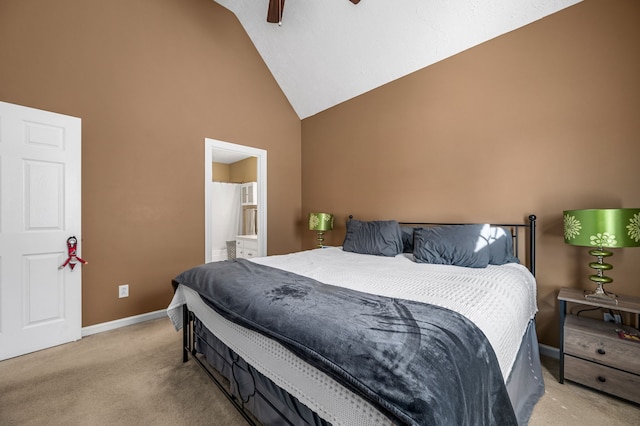 carpeted bedroom with ceiling fan, ensuite bath, and high vaulted ceiling