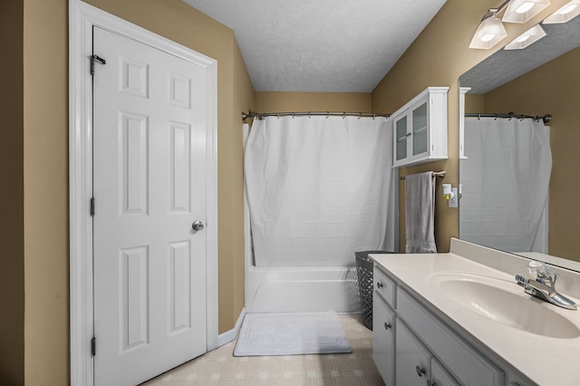 bathroom featuring vanity, a textured ceiling, and shower / tub combo