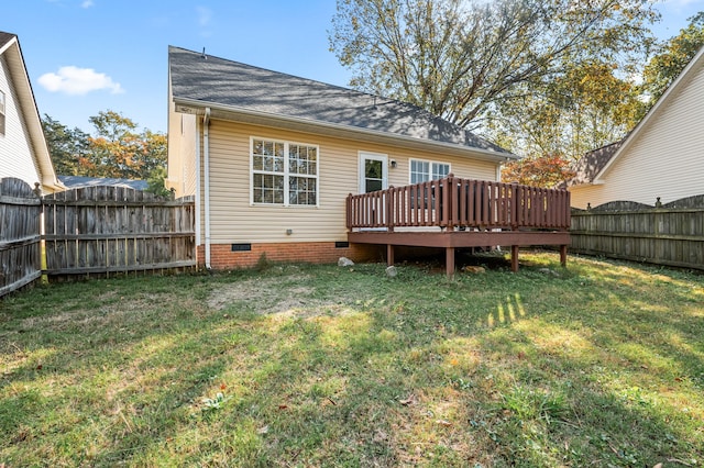 rear view of house with a lawn and a deck