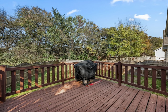 wooden terrace with area for grilling and a lawn