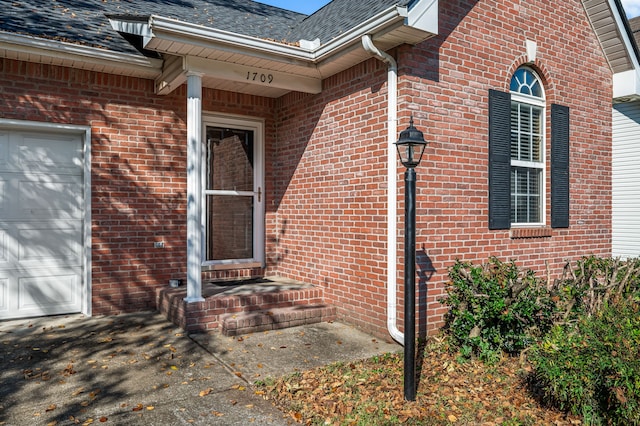 view of exterior entry featuring a garage