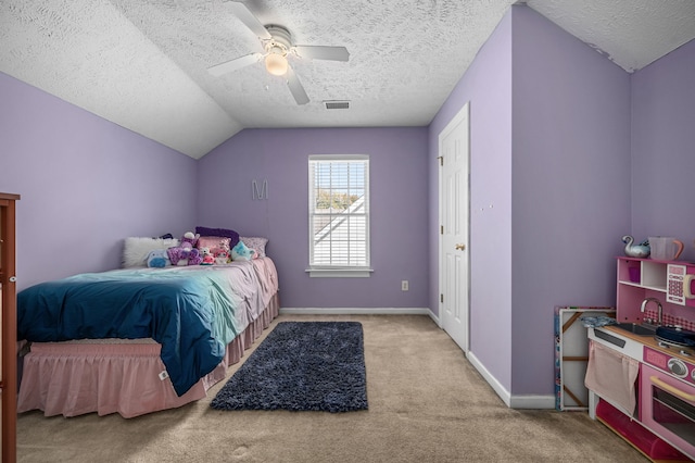 carpeted bedroom with lofted ceiling, a textured ceiling, and ceiling fan