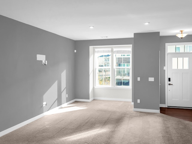 foyer featuring carpet flooring