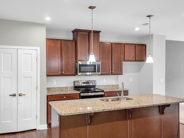 kitchen with pendant lighting, appliances with stainless steel finishes, sink, and dark hardwood / wood-style floors