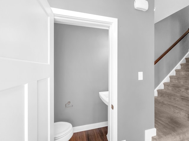 bathroom with hardwood / wood-style floors and toilet