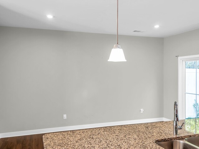 unfurnished dining area with hardwood / wood-style flooring and sink