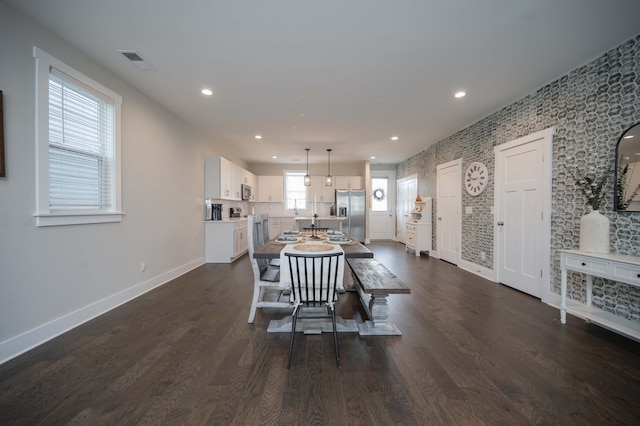 dining room with dark hardwood / wood-style floors and a healthy amount of sunlight