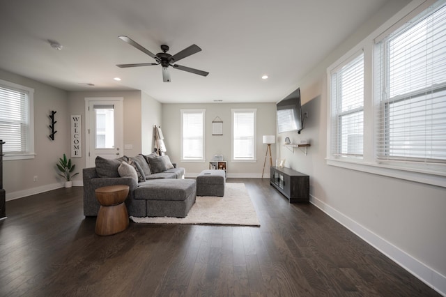 living room with dark wood-type flooring, a healthy amount of sunlight, and ceiling fan