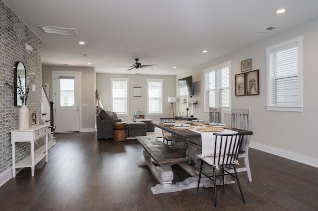 dining space with dark hardwood / wood-style flooring and ceiling fan