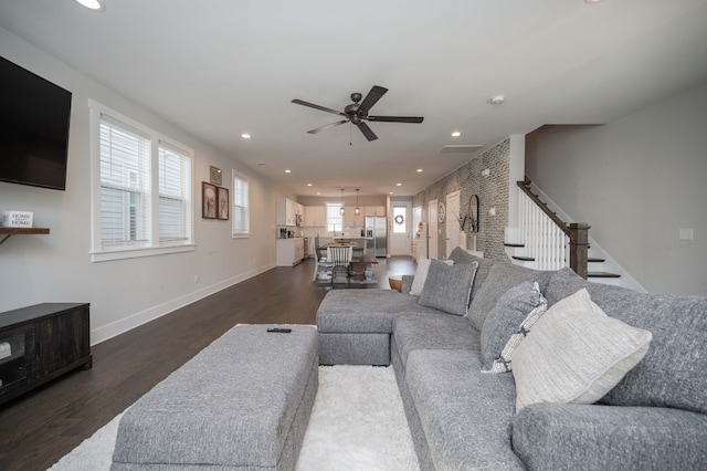 living room with ceiling fan and dark hardwood / wood-style floors