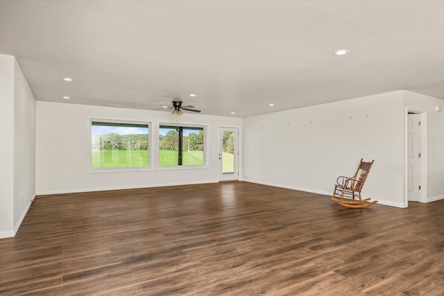 unfurnished living room with dark wood-type flooring and ceiling fan