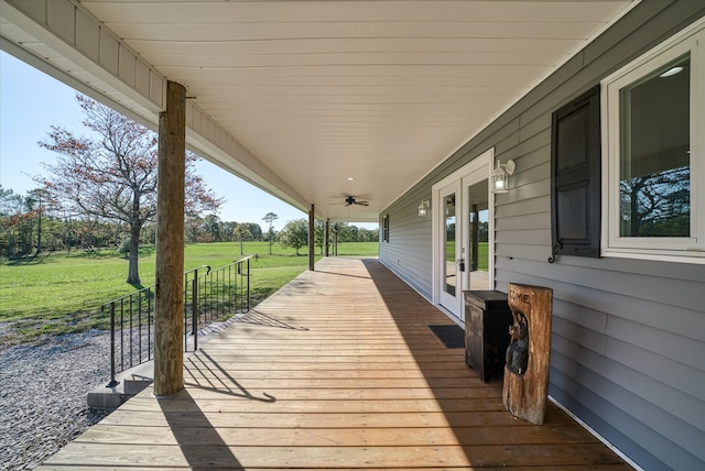 wooden deck featuring a yard