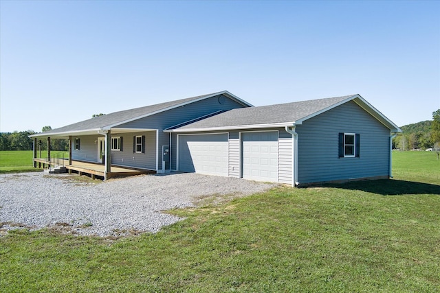 308 Huse Watson Rd, Oakdale, TN 37829 - view of front of home featuring a garage, a front yard, a porch, and gravel driveway