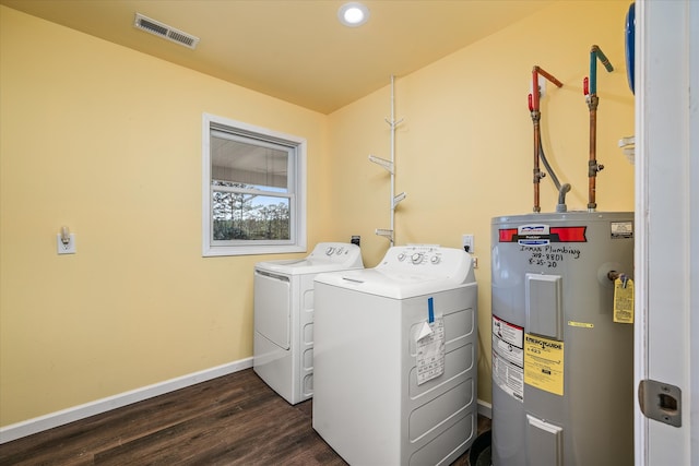 laundry room with electric water heater, dark hardwood / wood-style floors, and independent washer and dryer