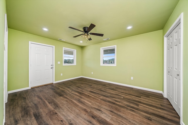 unfurnished bedroom featuring dark wood-type flooring and ceiling fan