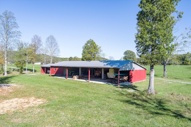 exterior space with an outbuilding and a front lawn