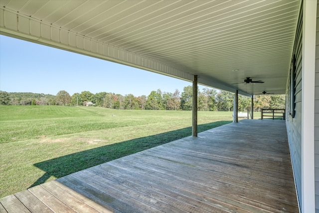 wooden deck featuring ceiling fan and a yard