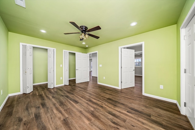 unfurnished bedroom featuring dark hardwood / wood-style flooring and ceiling fan