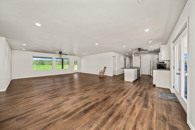 unfurnished living room with dark hardwood / wood-style floors