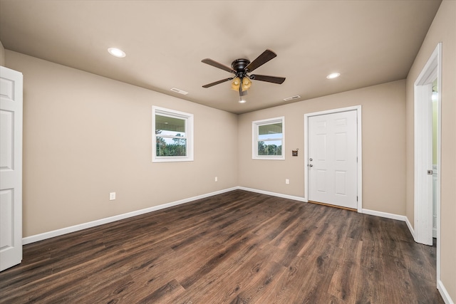 unfurnished room featuring dark wood-type flooring and ceiling fan