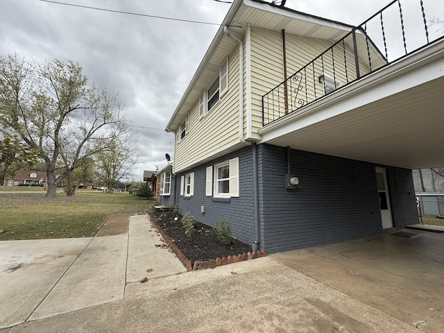 view of property exterior with a balcony and a yard