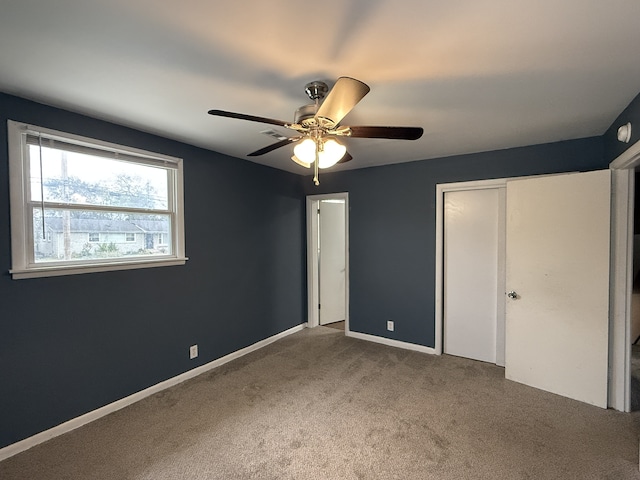 unfurnished bedroom featuring ceiling fan and carpet floors