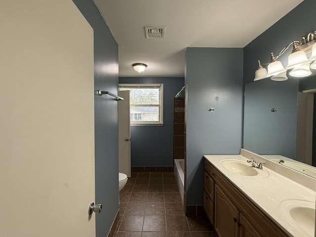 bathroom featuring tile patterned floors, vanity, and toilet