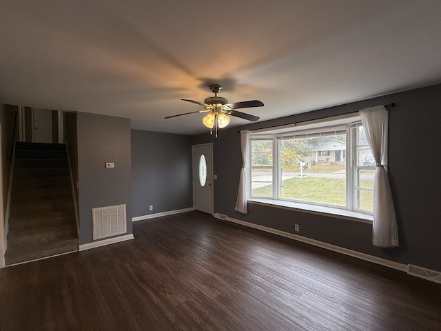 unfurnished living room featuring ceiling fan and dark hardwood / wood-style floors