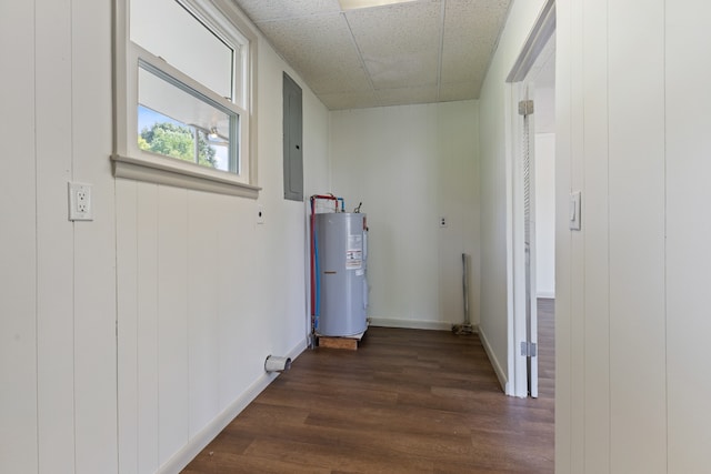 hallway featuring wood walls, electric panel, a drop ceiling, electric water heater, and dark hardwood / wood-style flooring