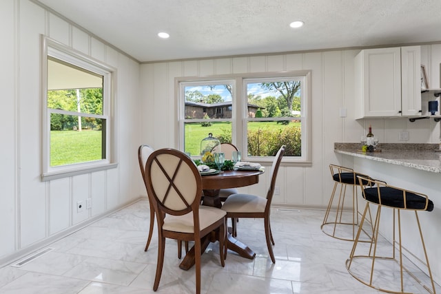 dining room featuring a textured ceiling