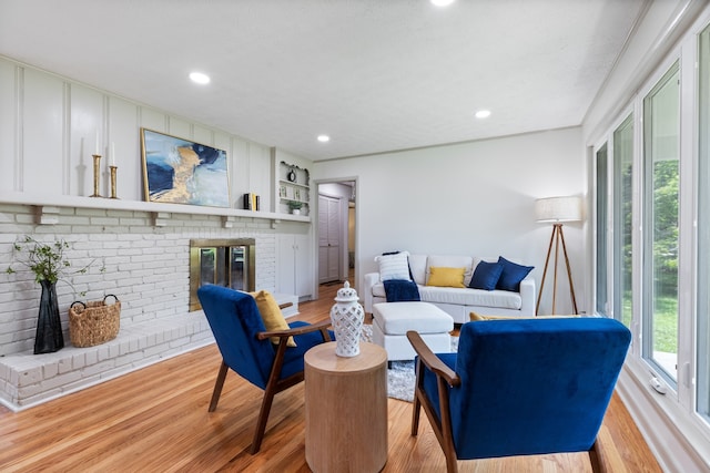 living room with a fireplace and light hardwood / wood-style floors