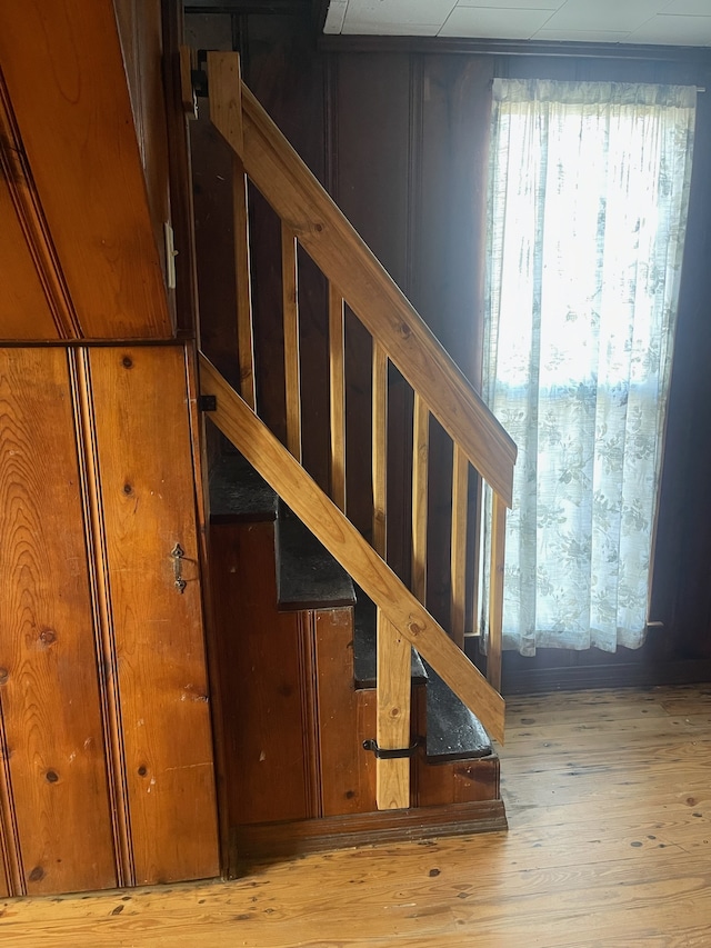 stairs featuring hardwood / wood-style floors