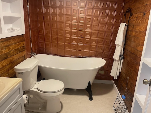 bathroom featuring tile patterned flooring, vanity, a bath, and toilet