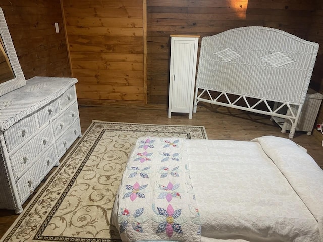 bedroom featuring wooden walls