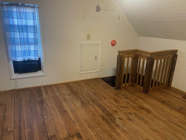 bonus room featuring cooling unit, vaulted ceiling, and hardwood / wood-style flooring