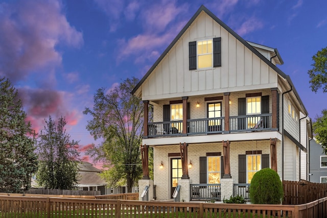 view of front of house with covered porch and a balcony