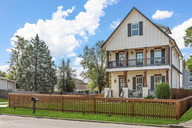 view of front of property featuring a balcony, a front yard, and a porch