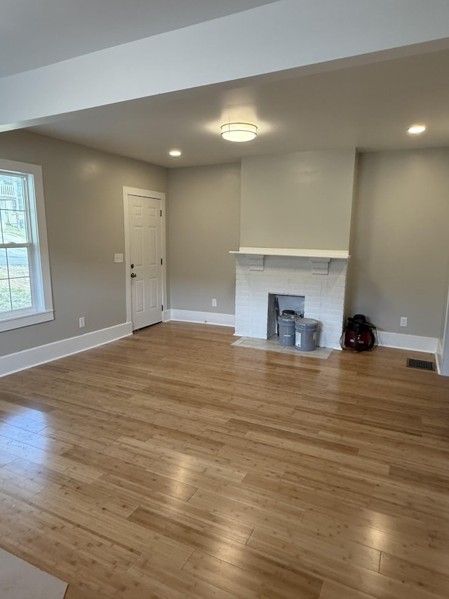 unfurnished living room with visible vents, recessed lighting, baseboards, and wood finished floors