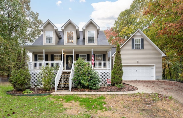 cape cod-style house with a garage and covered porch