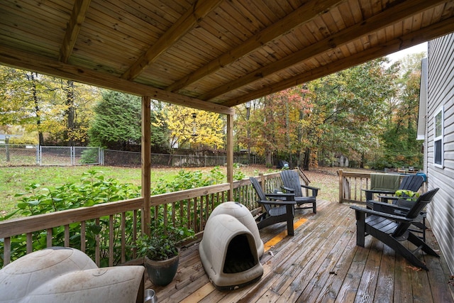 wooden terrace featuring a lawn