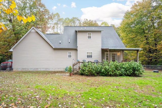 rear view of house with a lawn