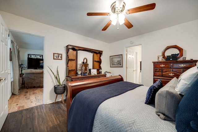 bedroom with ceiling fan and dark hardwood / wood-style floors