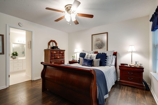 bedroom featuring ensuite bath, ceiling fan, dark hardwood / wood-style floors, and a textured ceiling