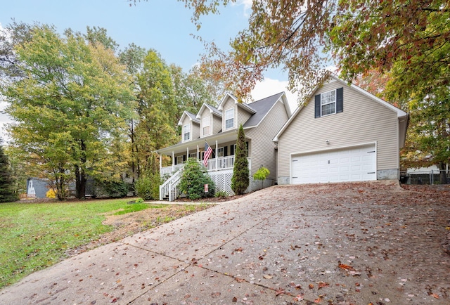 view of front of home featuring a front yard, a garage, and covered porch