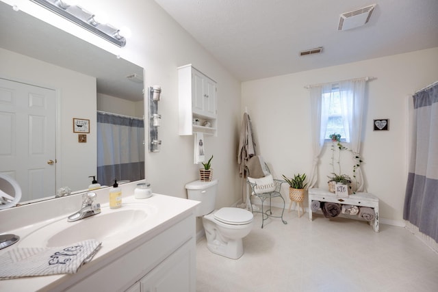 bathroom with toilet and vanity