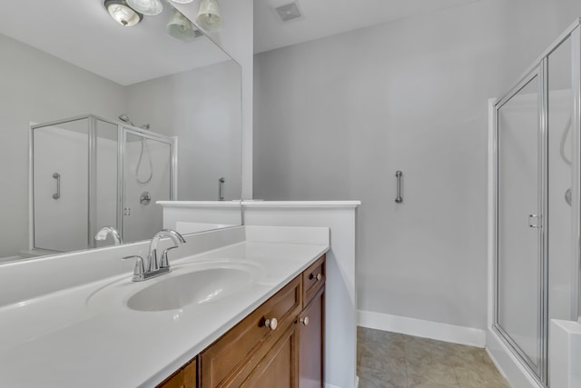 bathroom featuring vanity, tile patterned floors, and a shower with shower door