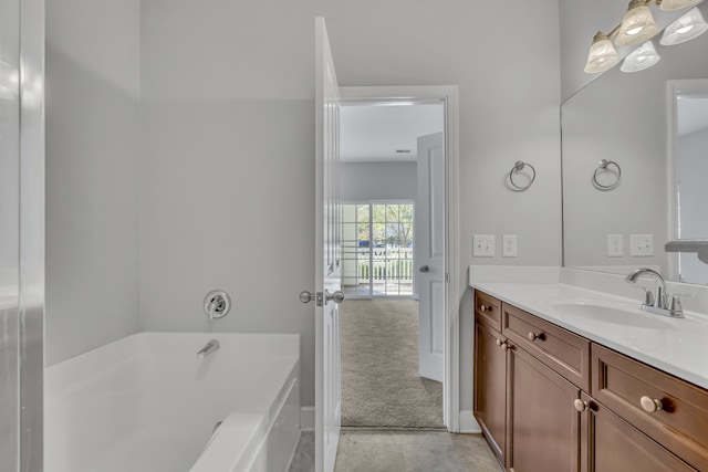 bathroom featuring a tub to relax in and vanity